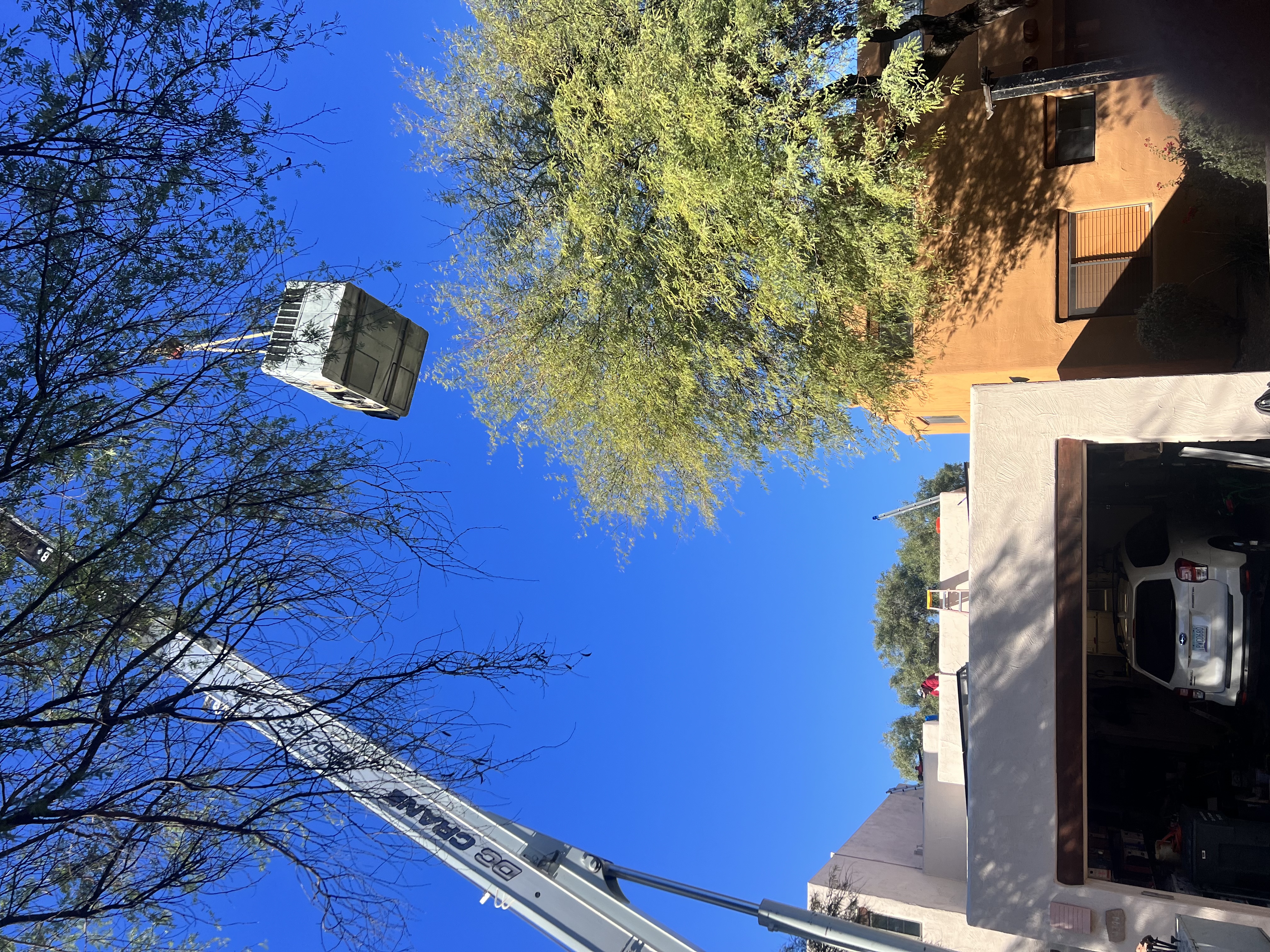 Portfolio image of SEER HVAC work done with a crane lift that is replacing an AC unit over a commercial building located in Phoenix, Arizona.